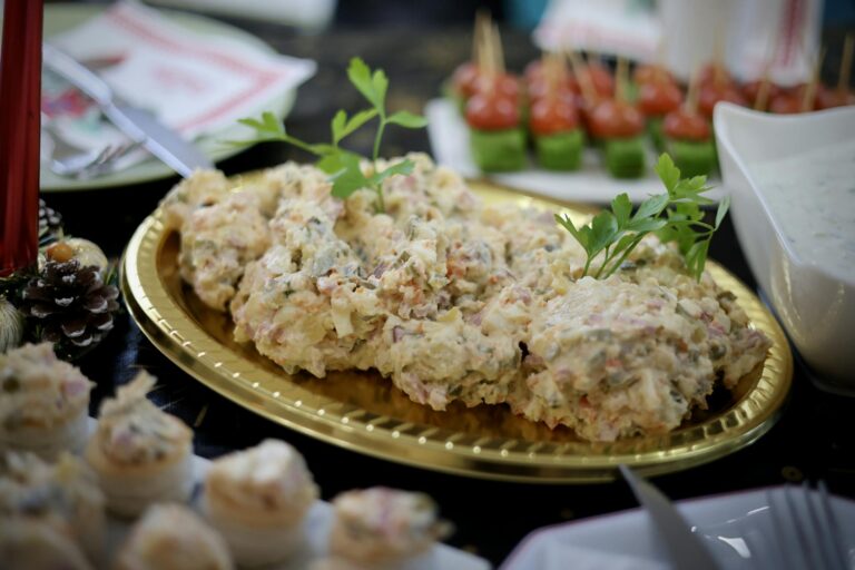 Close-up of festive appetizers and salad on a decorated table.